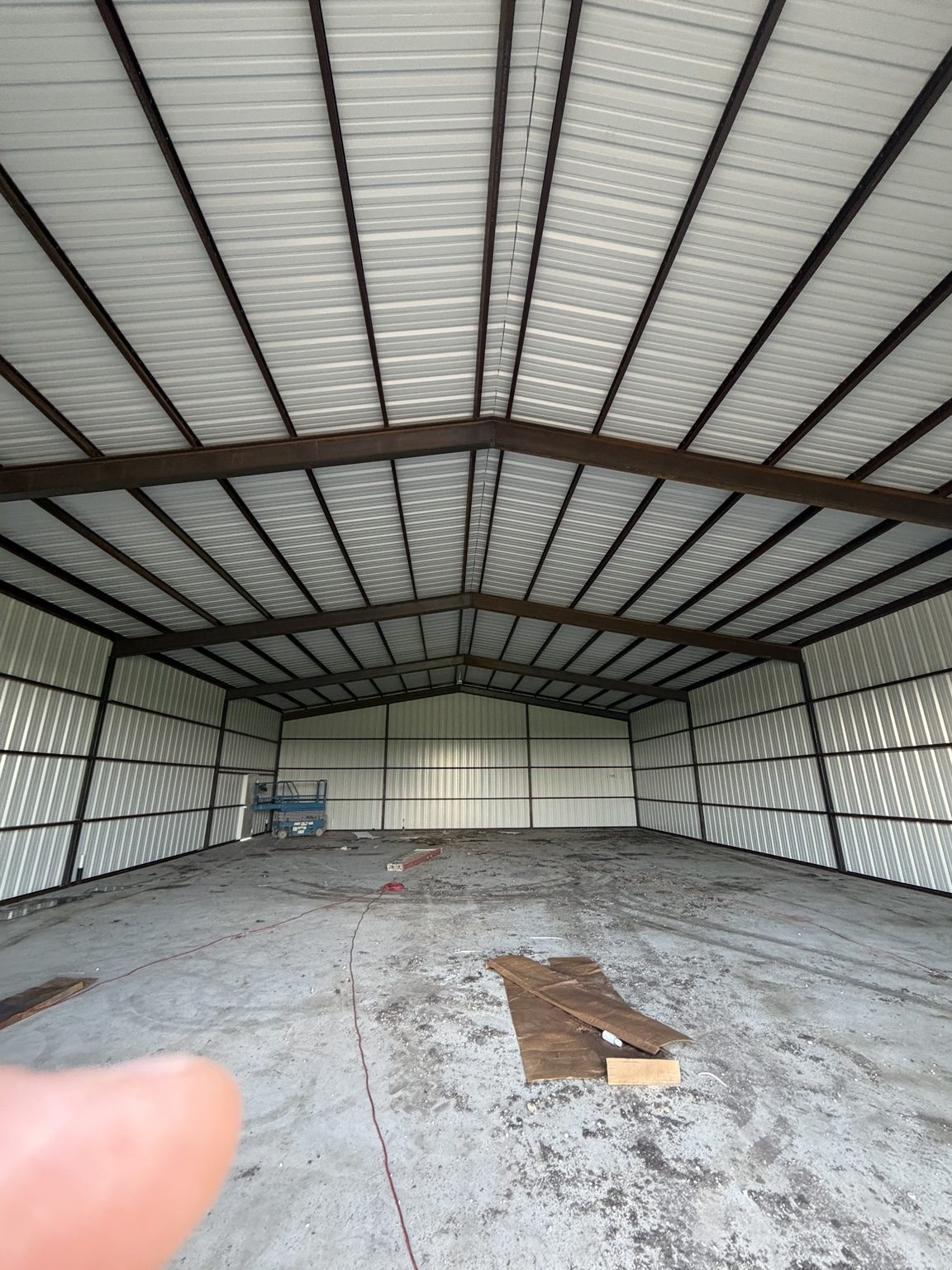 Interior steel framing and metal roof of a large shop
